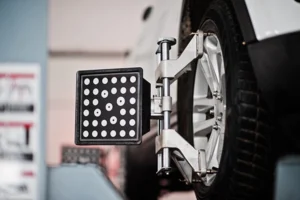 White SUV on alignment rack