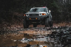 Silver Toyota FJ Cruiser off-roading over water